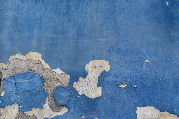 Peeling paint on cement wall texture. Pattern of rustic blue grunge material.