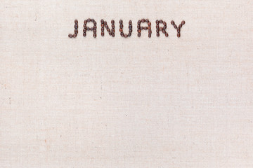 The word January written with coffee beans shot from above, aligned at the top.