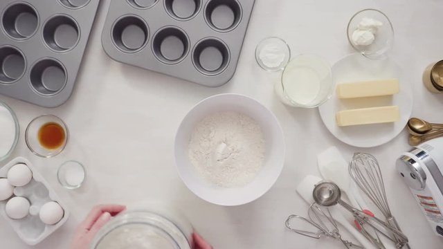 Flat lay. Step by step. Craking white organic eggs into a small glass bowl.
