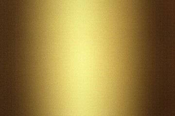 Light shining on golden metallic plate in dark room, abstract texture background