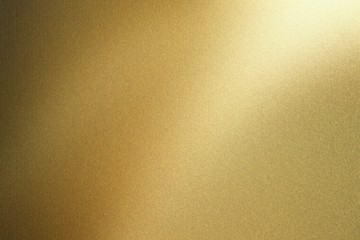 Light shining on gold steel wall, abstract texture background
