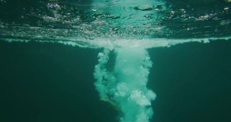 Young adventurous woman cliff jumping in green jungle paradise, summer adventure fun