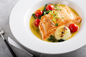 Salmon sauteed with cherry tomatoes and greens
