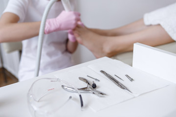 Tools manicure set on the background of the pedicure process in the beauty salon