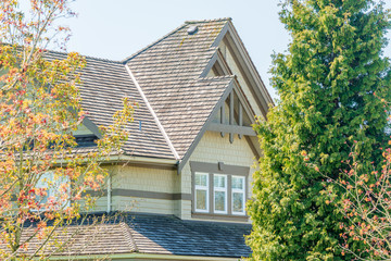 The top of the house or apartment building with nice window.