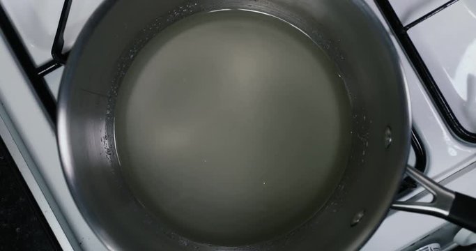 Shot of sugar and water boiling in a pan to make syrup for a tasty desert &mdash; Sugar, Water - 4K shot at 60pfs