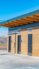 Clear Vertical Public restrooms with security camera installed beneath the flat roof