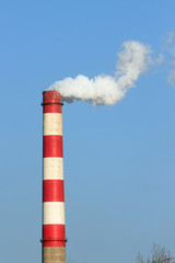 A chimney belching with smoke