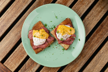 Crepes with poached egg, grilled bacon, cheese and herbs