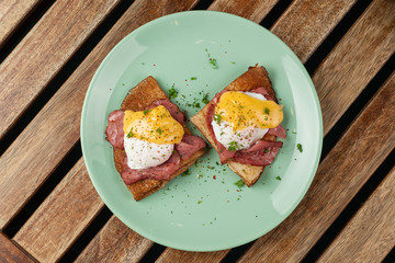 Crepes with poached egg, grilled bacon, cheese and herbs