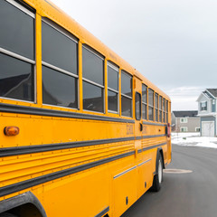 Square Exterior view of a yellow school bus with a red stop sign and signal lights