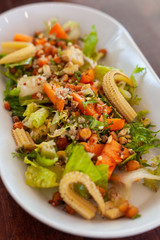 Vegan salad with greens, mini-corn, chickpea and quinoa