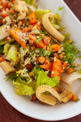 Vegan salad with greens, mini-corn, chickpea and quinoa
