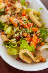 Vegan salad with greens, mini-corn, chickpea and quinoa