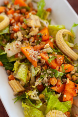 Vegan salad with greens, mini-corn, chickpea and quinoa