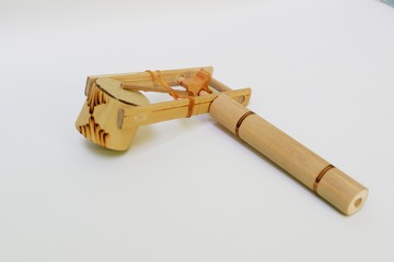 Traditional toy made from bamboo (klotokan,otok-otok) isolated on white background with shadow. Top view close up details. 
