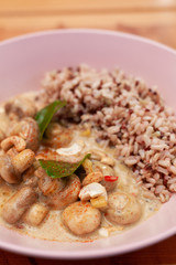 Close up of vegetarian nutritious meal with boiled wild rice and champignons is a coconut milk gravy
