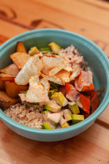 Vegetarian poke bowl with avocado, tomatoes, quinoa, rice, potato and grilled pumpkin
