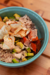 Vegetarian poke bowl with avocado, tomatoes, quinoa, rice, potato and grilled pumpkin
