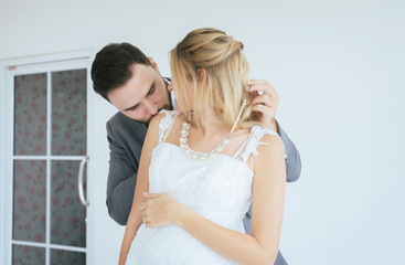 Groom with bride romantic couple is kissing together on white background,Positive thinking in wedding day