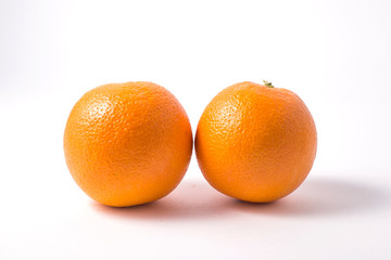 Glass jar with orange jam and orange on white background