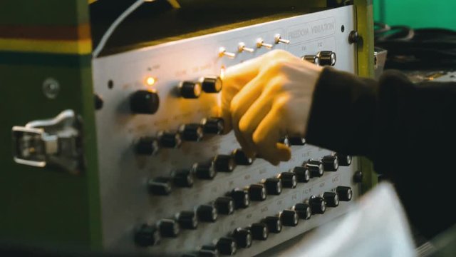 Slow motion shot of a hand using a sound system controller in a reagge party.