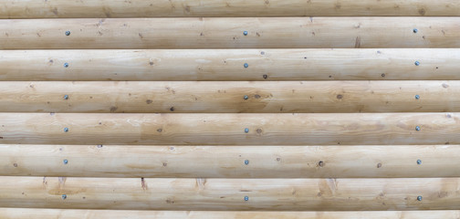 The logs are light yellow in color. Wooden plank background
