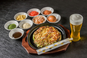 お好み焼き 広島焼き Okonomiyaki is a Japanese-style pancake