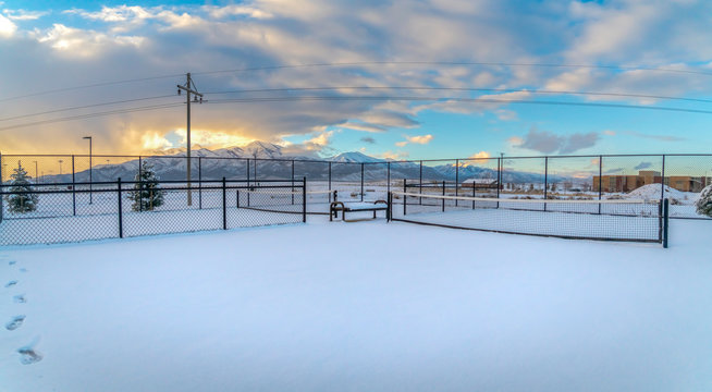Tennis courts on a landscape blanketed with snow during winter season