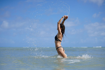 Woman in a bikini at the beach during summer