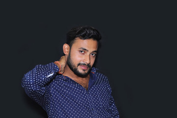 Fototapeta premium portrait of a handsome young man model with black background