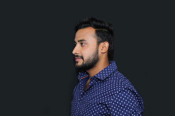 portrait of a young man model with black background side view