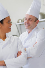 male and female chefs looking at eachother