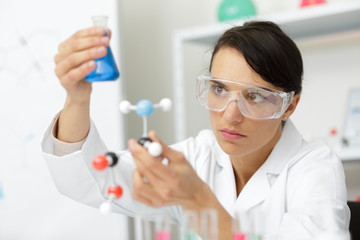 female scientist looking at dna chain