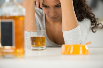 young woman drinking alcohol at home