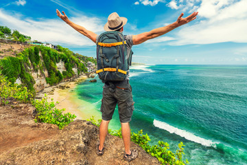 Active lifestyle travel backpacker enjoy amazing view tropical beach Bali from top of mountain cliff