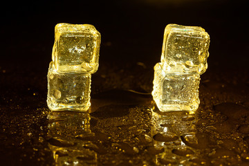 ice cubes on a reflections yellow light.