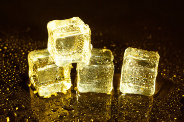 ice cubes on a reflections yellow light.