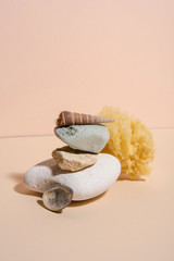 Spa stones on the top of each other in different pastel colors with sponge and shell. Beauty care abstract conception. Collection 1.