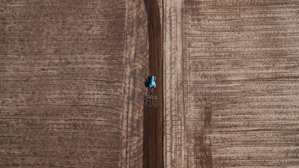 aerial view of tractor , combine cultivating field. drone shot. picture with space for text