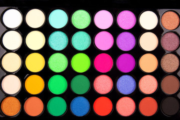 Close-up of eyeshadow palette with many shades.
