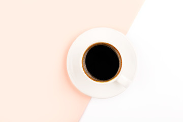 A cup of coffee on two colors background.