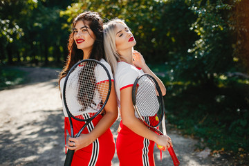 Girls in a summer park. Stylish ladies in a sports clothes