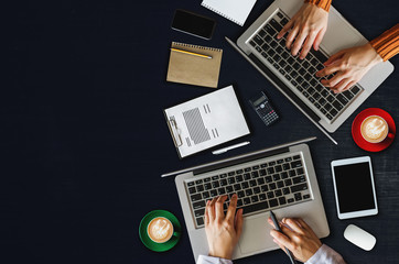 Top view of businessman Group of Multiethnic Busy People meeting with other in modern office with laptop computer, smartphone, tablet, coffee and document on table. People corporate business team conc