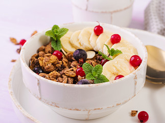 Breakfast. Bowl of homemade granola with yogurt and fresh berries. Table setting. Healthy food.