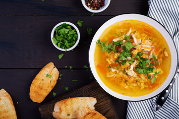 Red lentil soup with chicken meat and vegetables close-up on the table. Healthy food. Top view