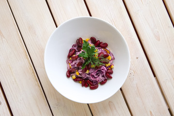 Vegetarian salad with red cabbage, red beans and corn