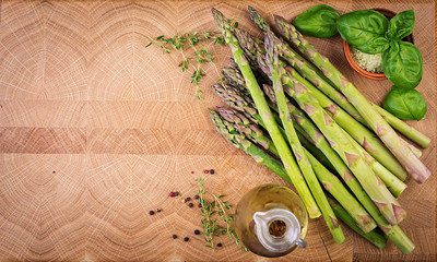 Fresh green asparagus on a rustic wooden table with copy space. Top view