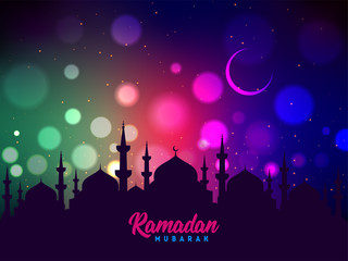 Fototapeta na wymiar Mosque silhouette on colorful shiny background for Islamic Festival of Ramadan Mubarak poster or banner design.