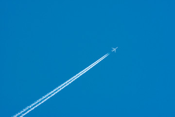 High in the sky flying Tu-134. Blue sky and plane.